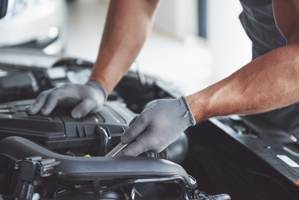 image of a mechanic repairing an car air box